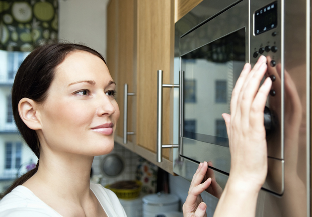A health expert advises leaving the room when the microwave is on, to help protect against leaked radiation. Photo / Getty